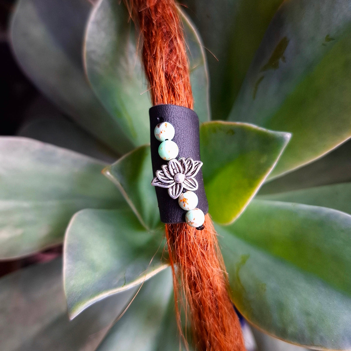 Black leather dreadlock cuff with lotus charm