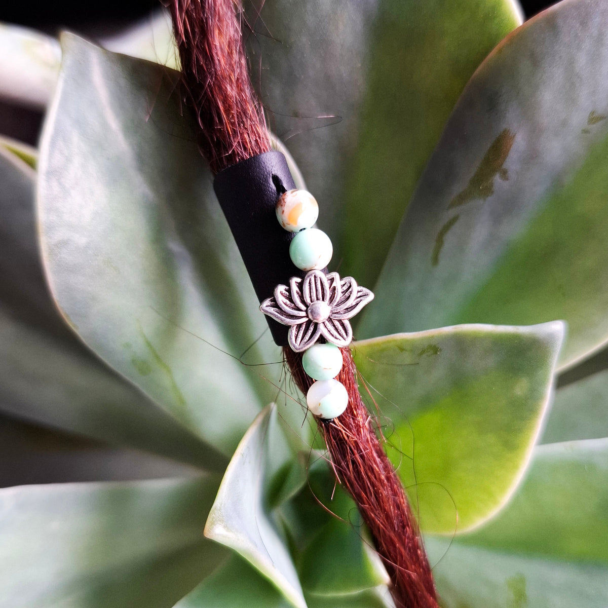 Black leather dreadlock cuff with lotus charm